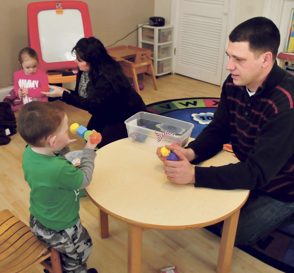 Teachers Jacquie Ayo, center, and Elijah Soll work with youngsters at the Children’s Center in Skowhegan. Research shows early intervention to be highly effective.