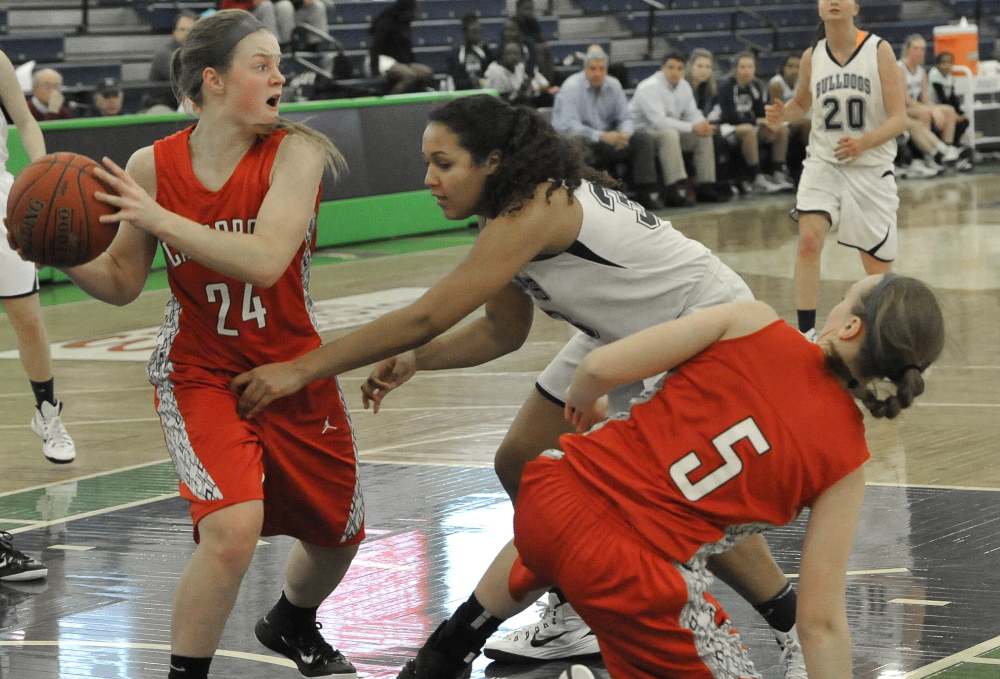 Sam Sparda of Scarborough looks for an outlet pass Tuesday night after grabbing a rebound in front of Gabrielle Wagabaza of Portland during Scarborough’s 42-33 victory.