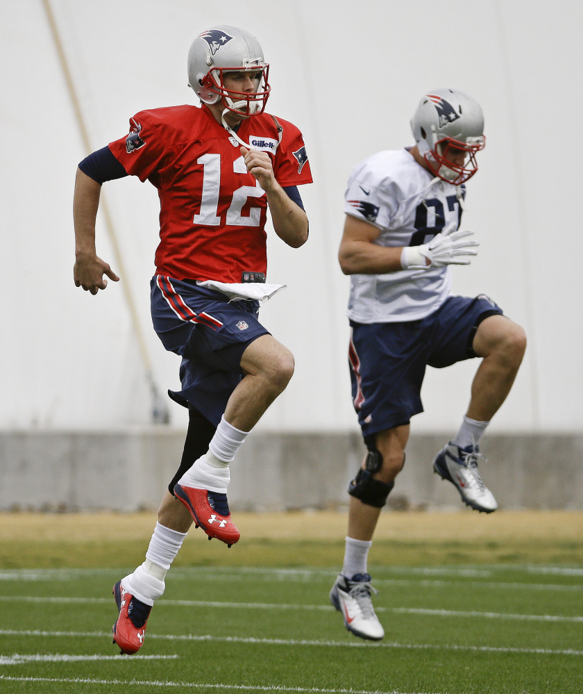 Keys to New England’s potent offense, quarterback Tom Brady, left, and tight end Rob Gronkowski, warm up in Tempe, Ariz. The Patriots face the Seahawks on Sunday in the Super Bowl.