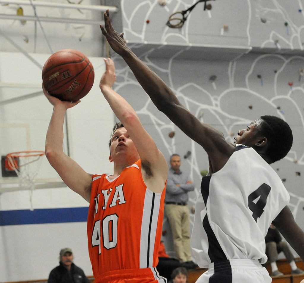 NYA's Patrick Jackson tries to shoot past Pine Tree Academy's JP Tshamala during a Jan. 21 matchup.