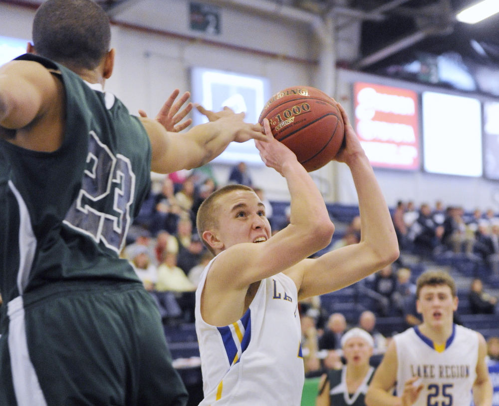 Brandon Palmer, while guarded by Deonte Ring of Spruce Mountain, looks to get off a shot for Lake Region, which will take on top-ranked Yarmouth in the quarterfinals at 9 p.m. Thursday at the Cross Insurance Arena.