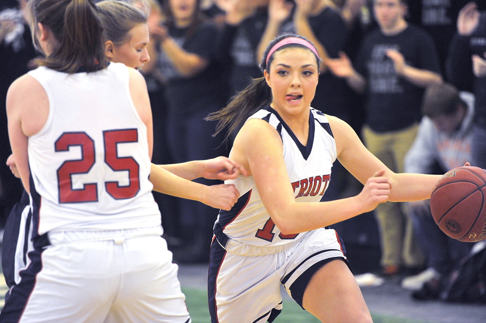 Alicia Dumont of Gray-New Gloucester gets a screen from teammate Skye Conley during a Western Class B girls’ basketball quarterfinal Tuesday afternoon against Poland at the Portland Expo. Gray-New Gloucester advanced with a 45-37 win.