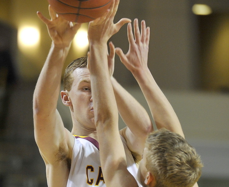 Quinn Hewitt of Cape Elizabeth shoots over Devin Scherer of Lincoln Academy during Cape’s 57-39 victory in a Western Class B semifinal Thursday night at the Cross Insurance Arena. The Capers (17-3) will play for the regional championship Saturday.