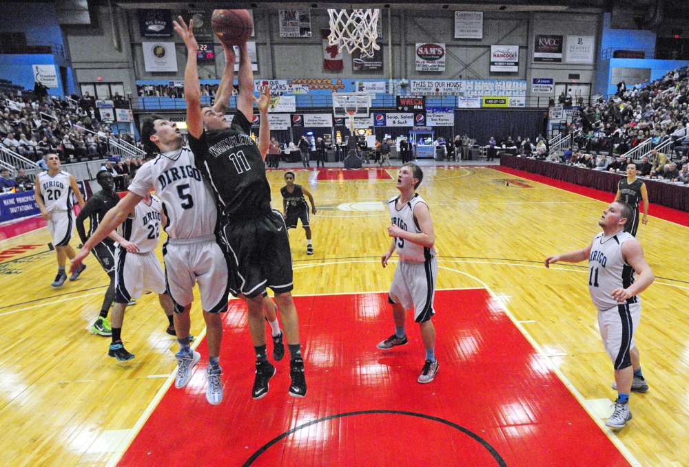 Gavin Arsenault, left, of Dirigo and Waynflete’s Milo Belleau battle for a rebound during their Western Class C boys’ basketball semifinal Friday night at the Augusta Civic Center. Dirigo won, 58-36.