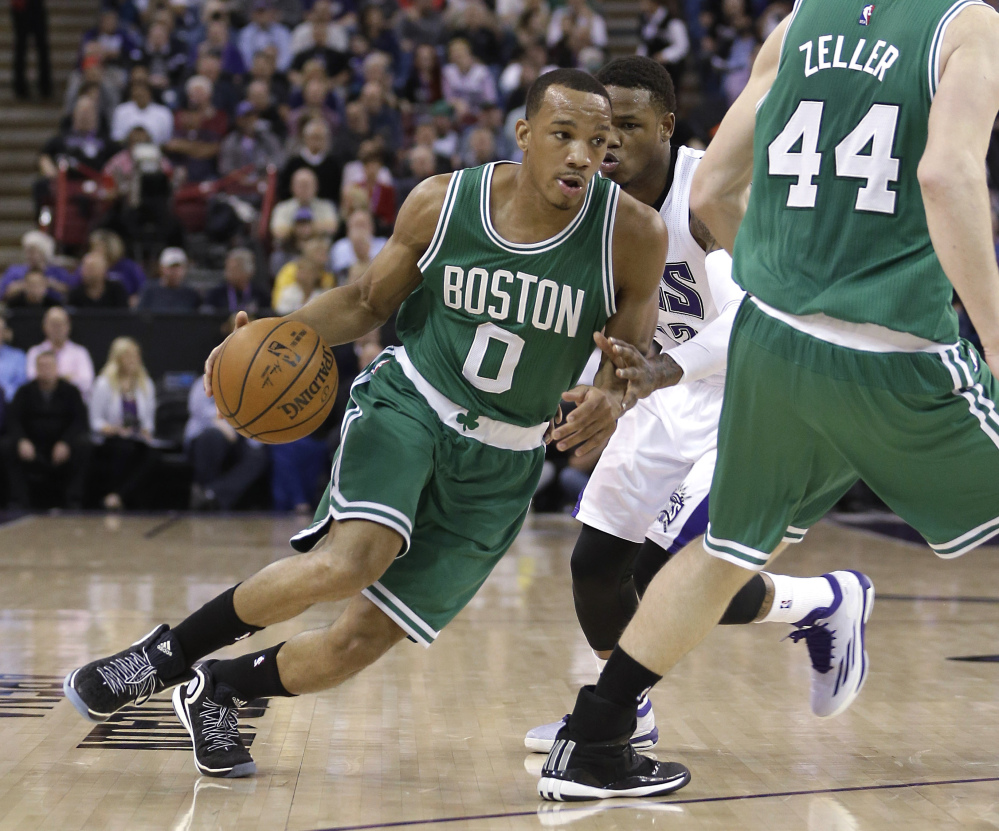 Boston Celtics guard Avery Bradley uses a screen by teammate Tyler Zeller, right, to shake off Sacramento Kings guard Ben McLemore during the first quarter of Friday night’s game in Sacramento, Calif. The Kings won, 109-101.