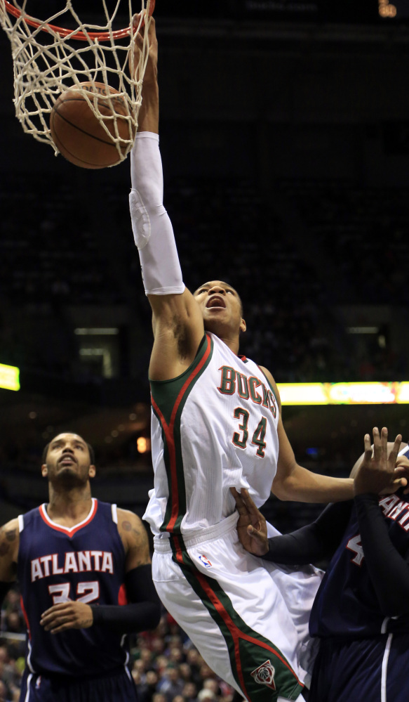 Milwaukee forward Giannis Antetokounmpo dunks during the first half of the Bucks’ 97-86 loss to Atlanta on Sunday.