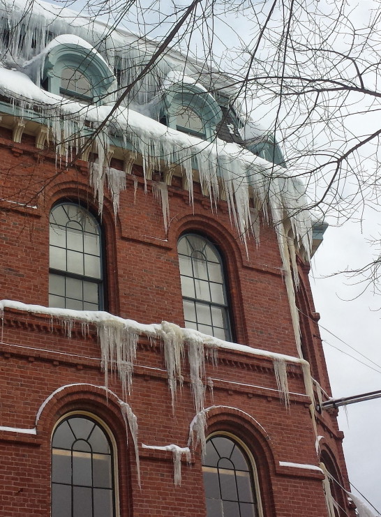 This Feb. 10 photo shows the ice buildup along Exchange Street. Ice from this building dropped and severely damaged a car Sunday.