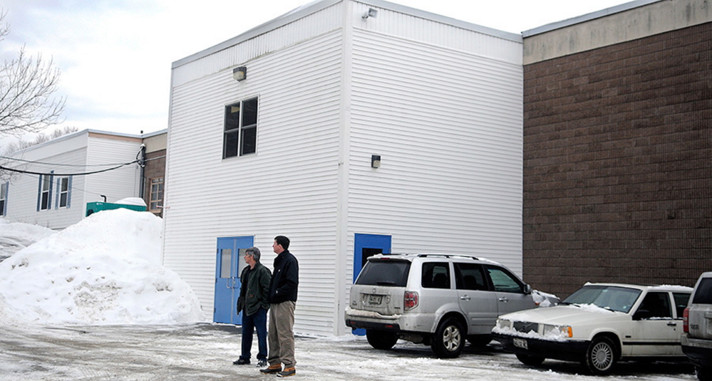 Bystanders wait Wednesday morning outside of the Teresa C. Hamlin School in Randolph, waiting for Kennebec County deputies to resolve a standoff with a man in a house near the school. School was canceled as a precaution and the standoff was over within an hour.