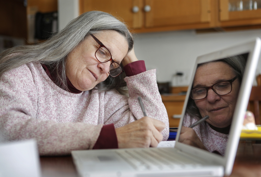 Mary Quinn Doyle takes notes while meeting with Ellen and Jack McAdam, owners of McDougal Orchards in Springvale, on March 2.