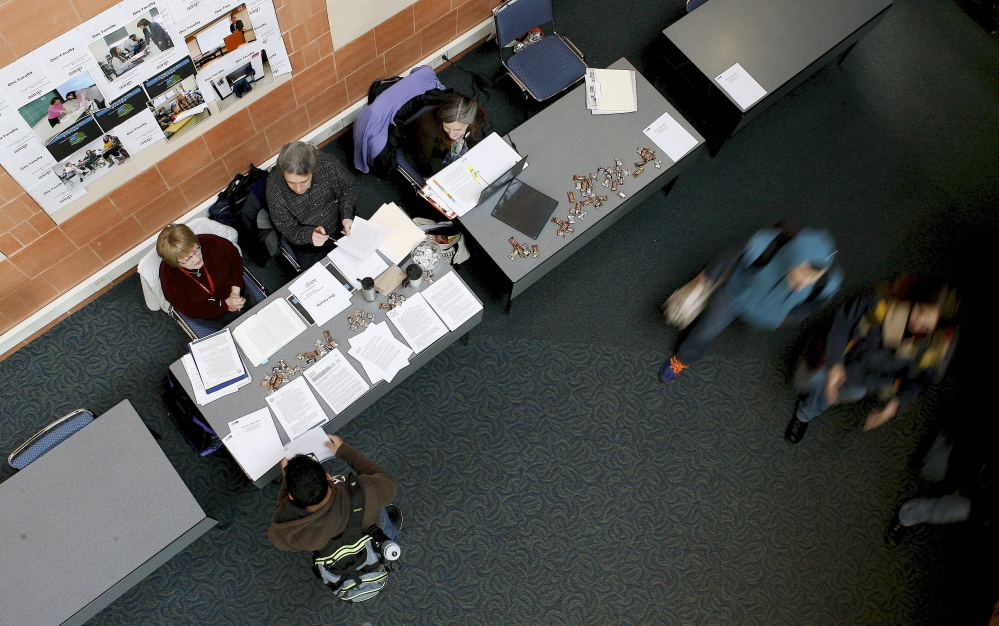 Students pass by as part-time educators at Central Connecticut State University participate in National Adjunct Walkout Day on Feb 25. Central’s adjuncts chose not to walk out of their classrooms because they felt it would be unfair to their students. They chose to hold the “grade-in” as a way to showcase some of the work they do without compensation.