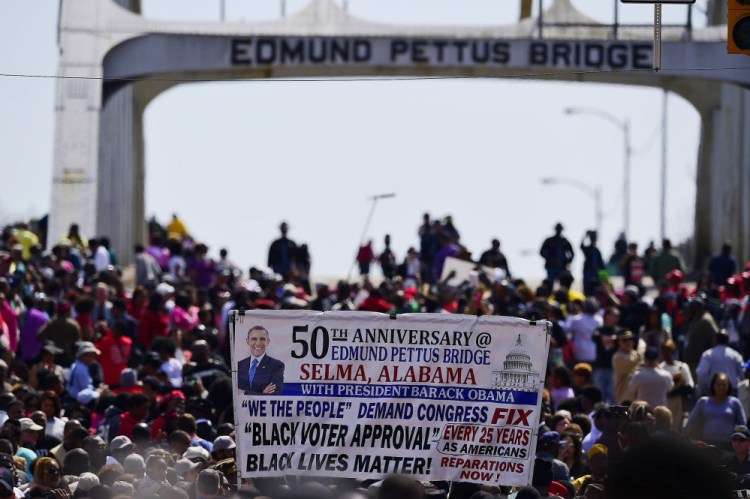 Crowds take a symbolic walk across the Edmund Pettus Bridge, Sunday in Selma, Ala.