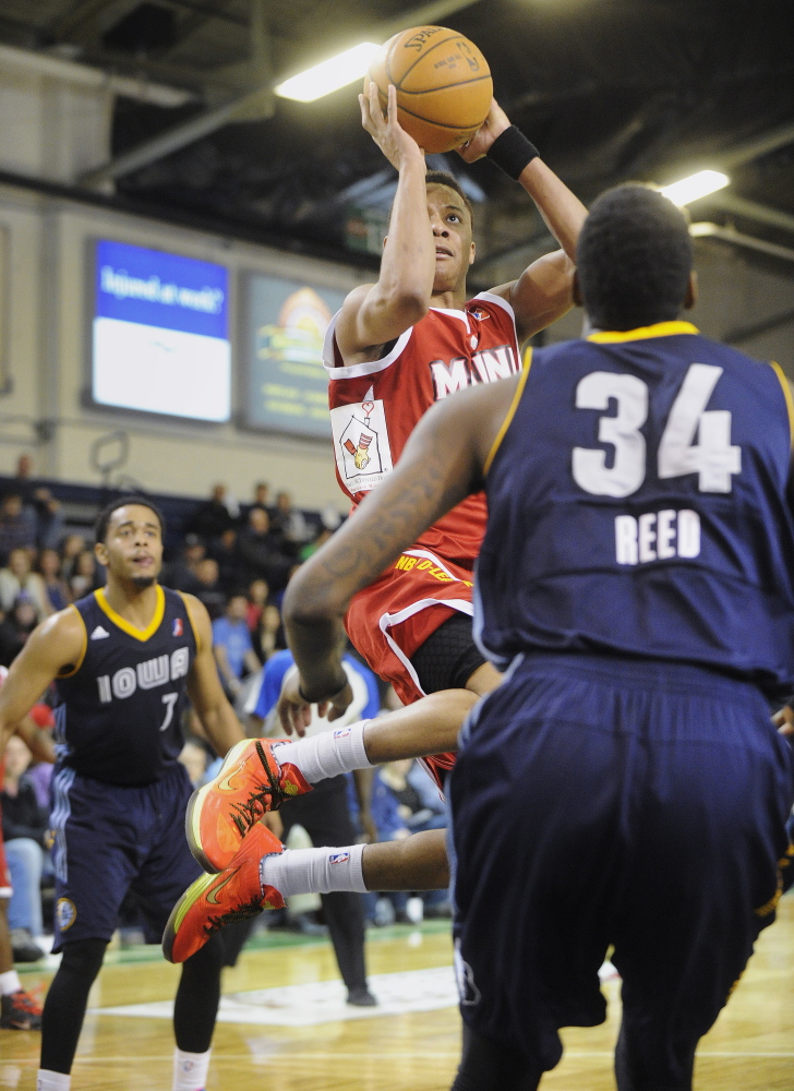 Maine’s Tim Frazier drives to the basket against Iowa’s Willie Reed during Friday night’s one-sided victory at the Expo.
John Ewing/Staff Photographer