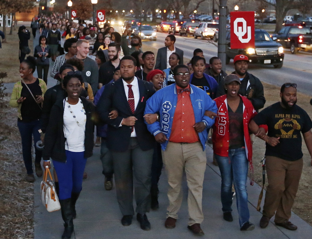 University of Oklahoma students march to the now-closed Sigma Alpha Epsilon fraternity house Tuesday after members of the fraternity were caught on video chanting a racial slur.