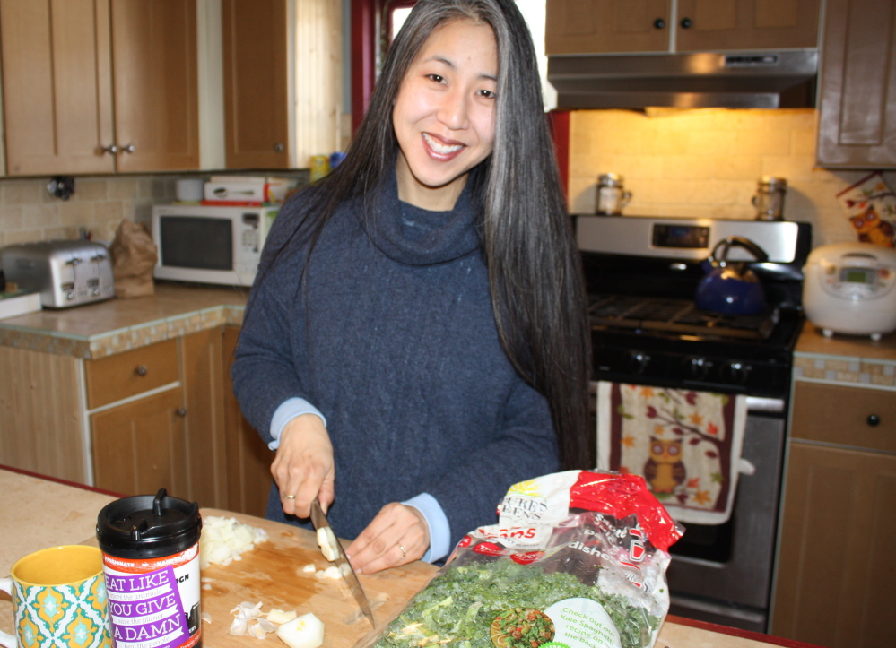 Kara Owens chops garlic in her Scarborough kitchen to use in a vegetable scramble. Now a vegan, Owens was a vegetarian briefly as a teenager, but her father was a butcher so it was hard to keep it up. Avery Yale Kamila photo