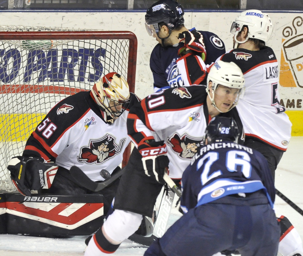 Pirates goalie Mike McKenna makes a save as the puck bounces in front of him in Wednesday night’s game at the Cross Insurance Arena. The Pirates beat St. John’s 6-0.