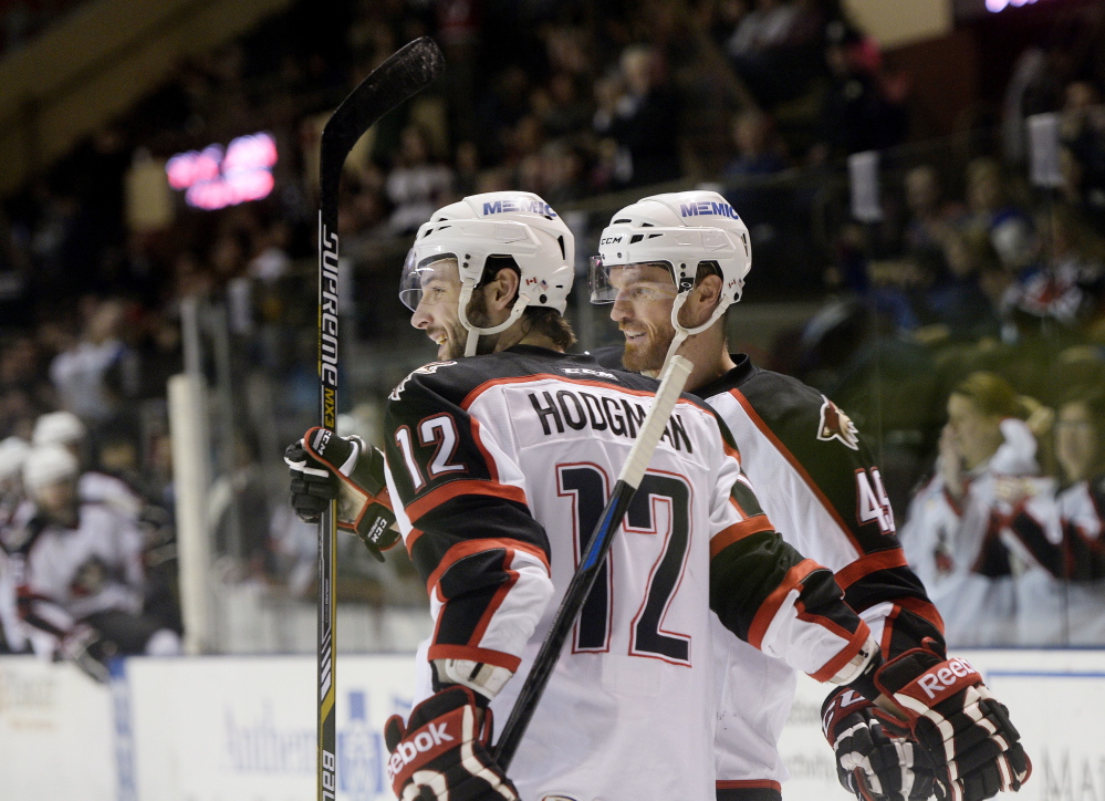 Portland Pirates Justin Hodgman, left, and Alex Bolduc celebrate a second-period goal against the St. John's Icecaps Thursday. 
Shawn Patrick Ouellette/Staff Photographer