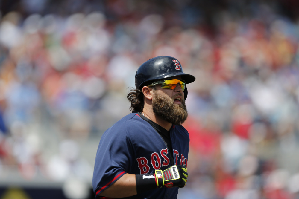 Boston Red Sox Mike Napoli runs toward first base after hitting a two-run home run against the Tampa Bay Rays during an exhibition spring training baseball game.