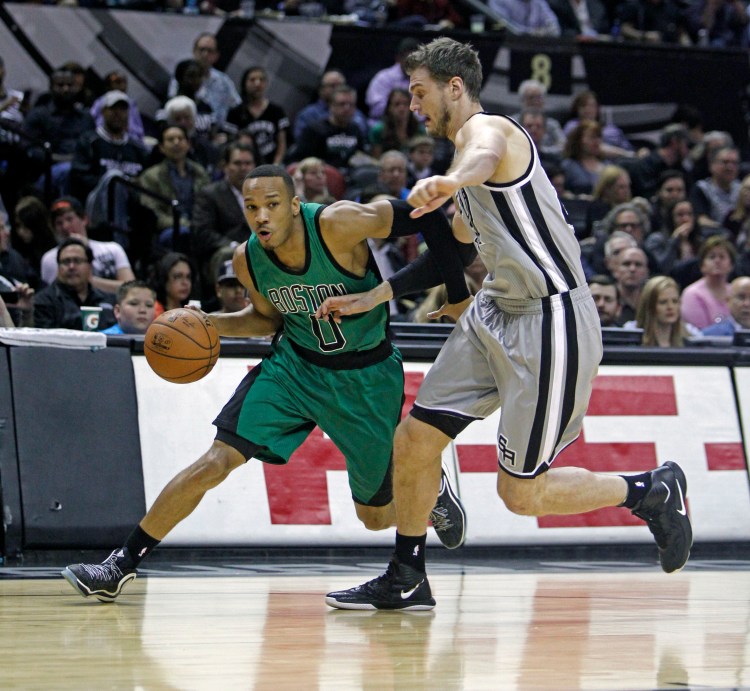 Boston's Avery Bradley drives around San Antonio's Tiago Splitter during the Spurs' 101-89 win Friday night.