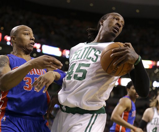 Detroit Pistons forward Caron Butler and Boston Celtics forward Gerald Wallace grapple over a loose ball in the second quarter Sunday in Boston. The Associated Press