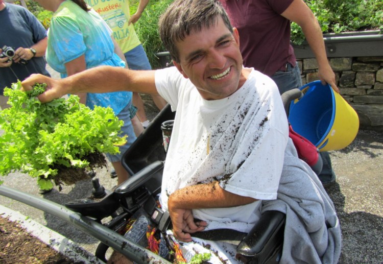 Horticultural therapy at the Coastal Maine Botanical Gardens in Boothbay delights a participant.