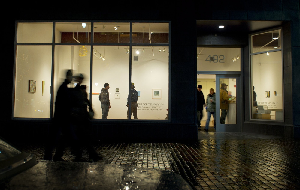 Patrons check out the scene inside Rose Contemporary, an art gallery on Congress Street, during a First Friday Art Walk. Congress Street will be closed to vehicular traffic for the art walk in June.