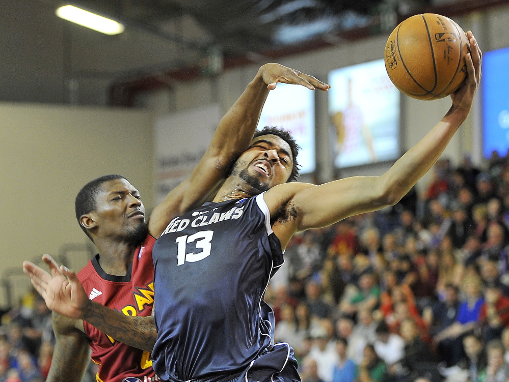 Maine’s James Young goes for a layup over the defense of Fort Wayne’s Marcus Simmons in playoff action at the Expo on Saturday. 