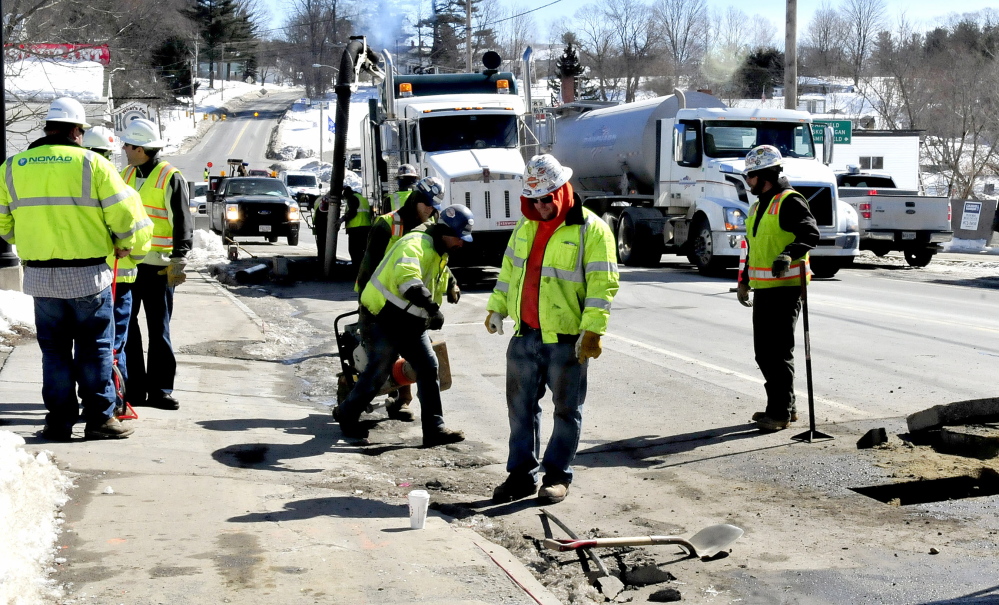 Employees of Summit Natural Gas of Maine and sub-contractors work on the gas pipeline in the center of Norridgewock on March 17, 2014. Summit will temporarily suspend service in the Waterville area to inspect equipment that may have been installed improperly.