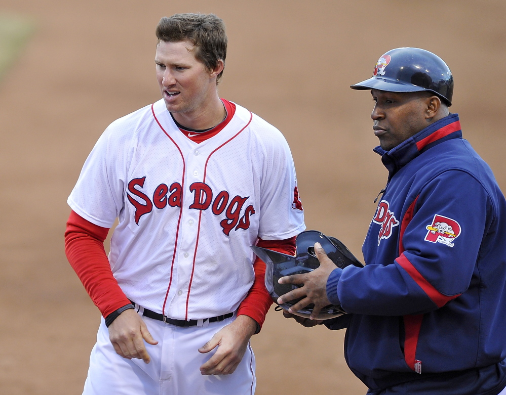 PORTLAND, ME - APRIL 14: First baseman Jantzen Witte prepares to take his position at first base as he talks with coach Joe Thurston after hitting the last out of the inning as the Portland Sea Dogs hosts New Britain Rock Cats in AA Baseball action at Hadlock Field. (Photo by Gordon Chibroski/Staff Photographer)