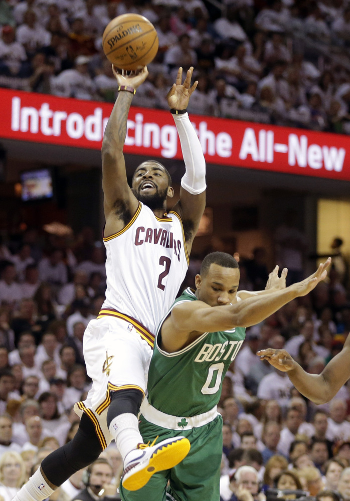 Kyrie Irving of the Cavaliers is fouled by Boston’s Avery Bradley during Sunday’s game in Cleveland. Irving made the shot on the way to a 30-point performance as Cleveland grabbed a 1-0 series lead.