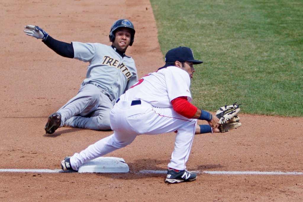 Portland's Carlos Asuaje waits for the throw from home while Trento's Cito Culver safely steals third base in the fifth inning at Hadlock Field on Saturday. Jill Brady/Staff Photographer