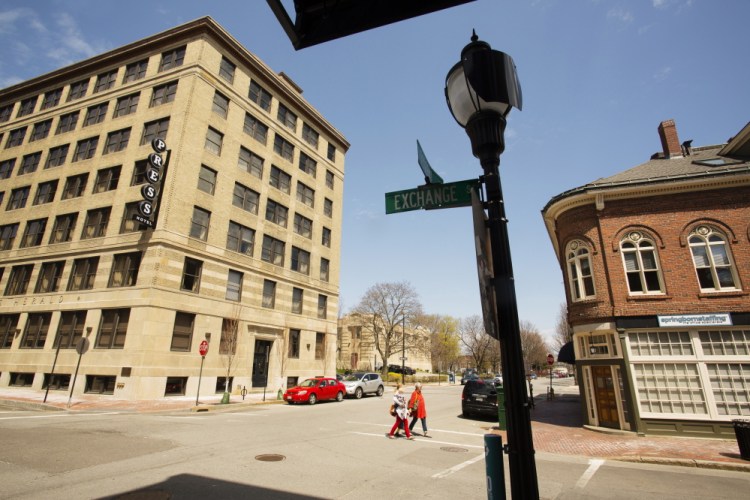 Pedestrians walk across Federal Street near the site of the proposed pop up park behind the new Press Hotel. Carl D. Walsh/Staff Photographer.