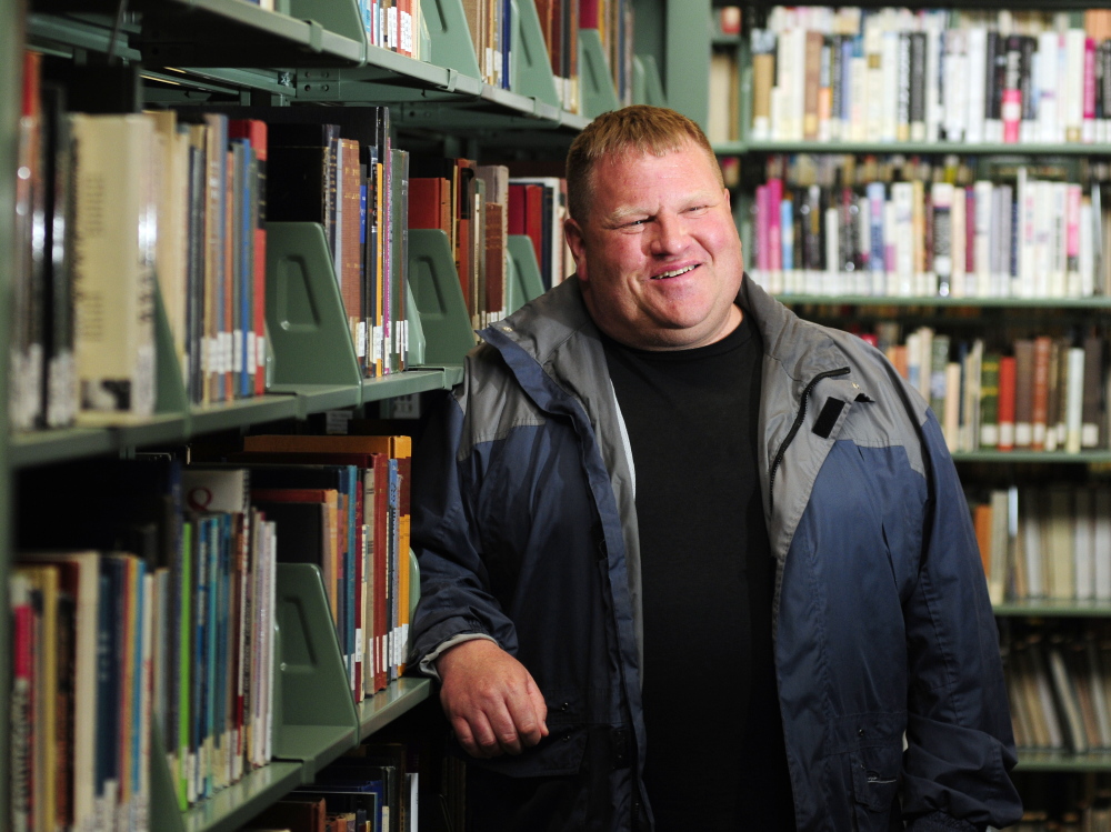 Commencement speaker and graduate Andrew Breault, 53, of South China, in the Bennett D. Katz Library at the University of Maine at Augusta.