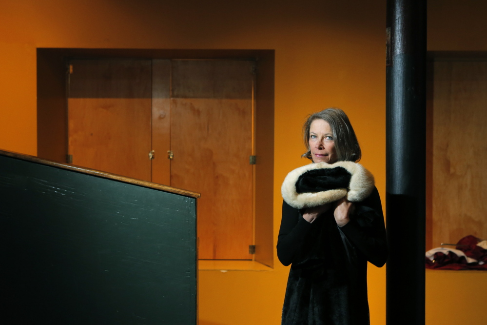 Elizabeth Peavey with a coat that belonged to her mother, which she uses as a prop in “My Mother’s Clothes Are Not My Mother.” Peavey has retooled the one-woman play and recently performed it in New York. She brings it back to Maine for two shows in June. 