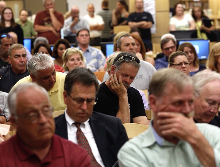 About 80 residents gather Thursday night at the Biddeford High School library for a special City Council meeting. Speakers addressed allegations of sexual abuse by two former city police officers. One resident said, "This issue is tearing my city apart."
Derek Davis/Staff Photographer