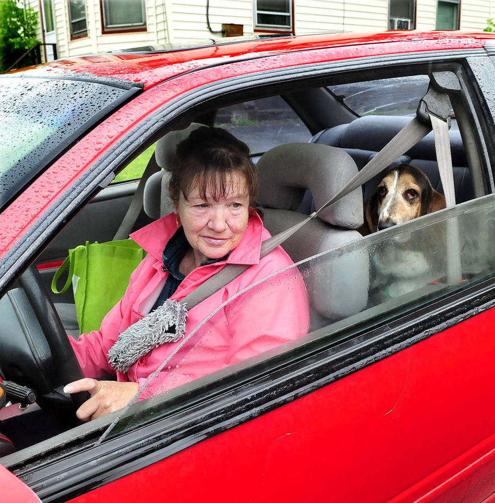 Donna Simpson and her dog, Emma Lou, speak near her apartment on Tuesday following a nearby brawl on May Street in Waterville. Simpson said she plans to move to a quieter neighborhood.