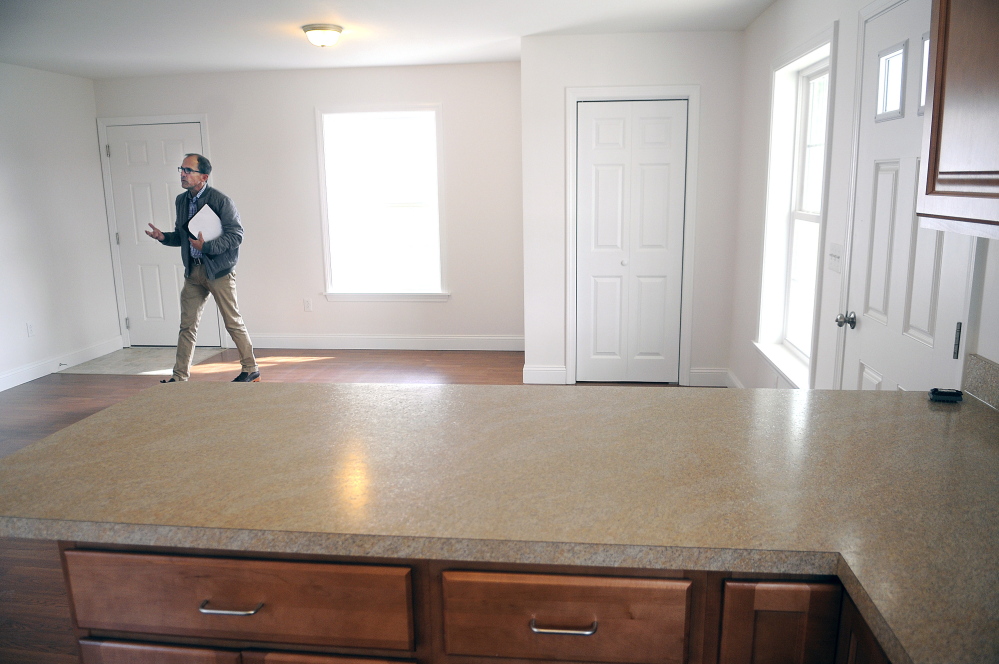 Real estate agent Perry McCourtney shows a vacant home Wednesday at Patriots Point in Augusta. The Augusta affordable-housing development, which has filled its lots slowly since breaking ground in 2008 is being rebranded to focus on veterans, who can use grant money to get discounts on the homes.