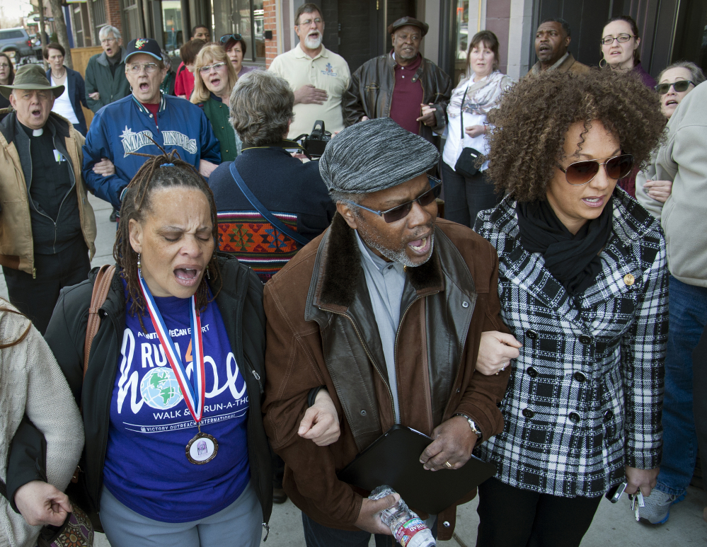 Spokane NAACP president Rachel Dolezal, right, marches at a rally in Spokane, Wash.