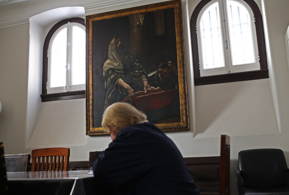 A woman reads a book at a Jewish synagogue in Lisbon. In March, Portugal enacted a law to grant citizenship to descendants of Sephardic Jews exiled during the Inquisition.