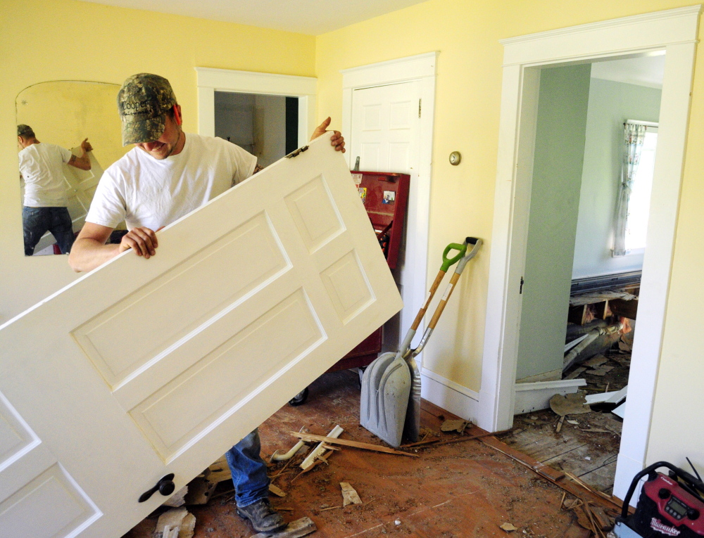 Wesley Jandreau carries out a door on Wednesday at the former Elizabeth Arden estate in Rome, which is being renovated for the Travis Mills Foundation.