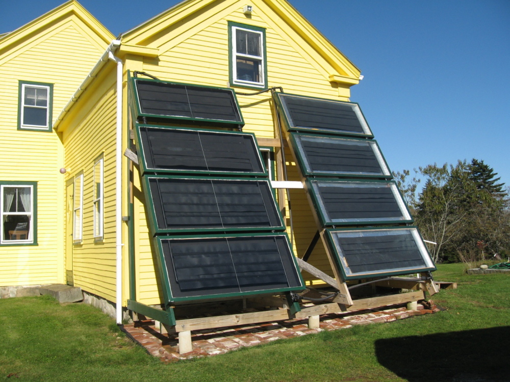 The humble Farmer made these solar water heaters in his barn, using glass found at the town dump.