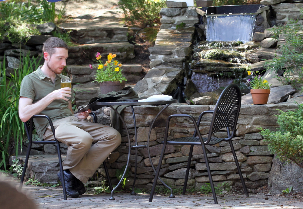 Phil Krause of Milwaukee peruses the menu on the patio.