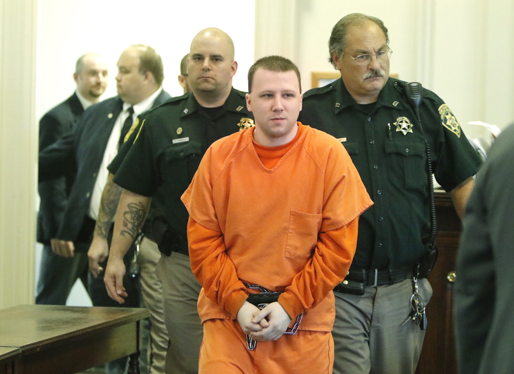 Derek Poulin is escorted into York County Superior Court in Alfred on Tuesday. Justice John O'Neil sentenced Poulin to life in prison for murdering his grandmother in Old Orchard Beach in 2012. Gregory Rec/Staff Photographer