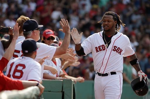 Hanley Ramirez is welcomed to the Red Sox dugout after hitting a home run last season. This year he's being told to concentrate less on slugging, more on athleticism. The Associated Press