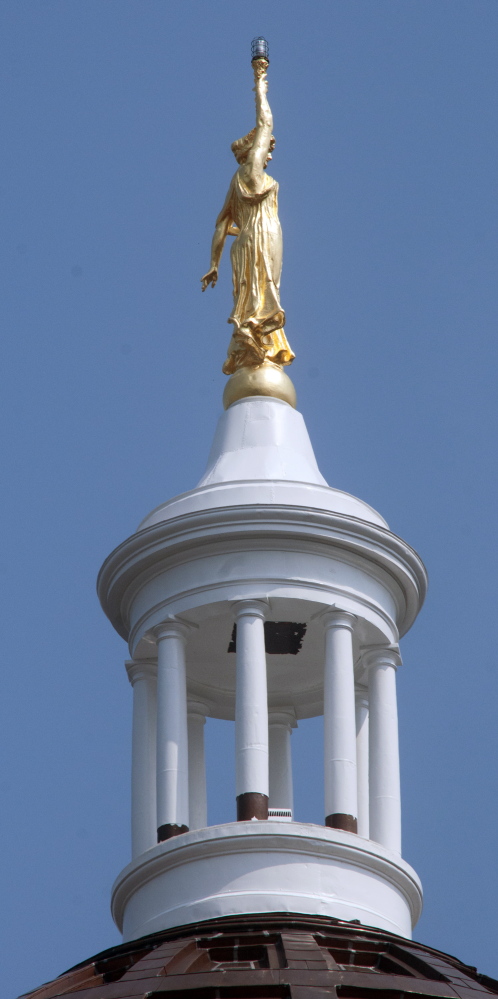 Peeling paint on the pillars around the State House dome in Augusta can be seen Wednesday.