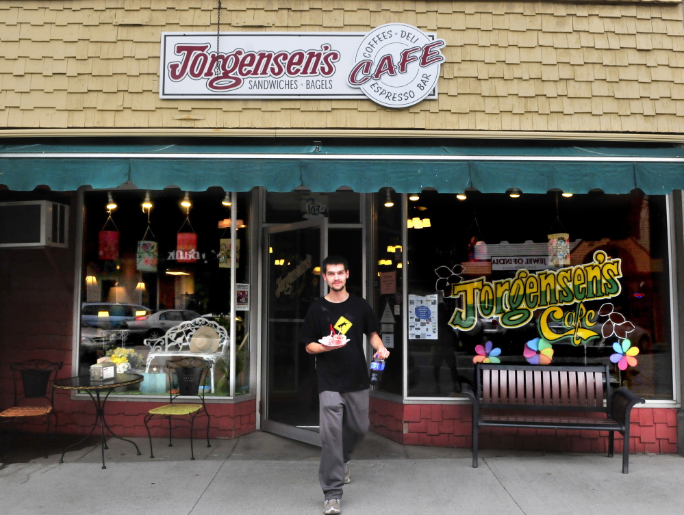 Autem Bolduc carries a tray of gelato from Jorgensen’s Cafe on Main Street in Waterville.