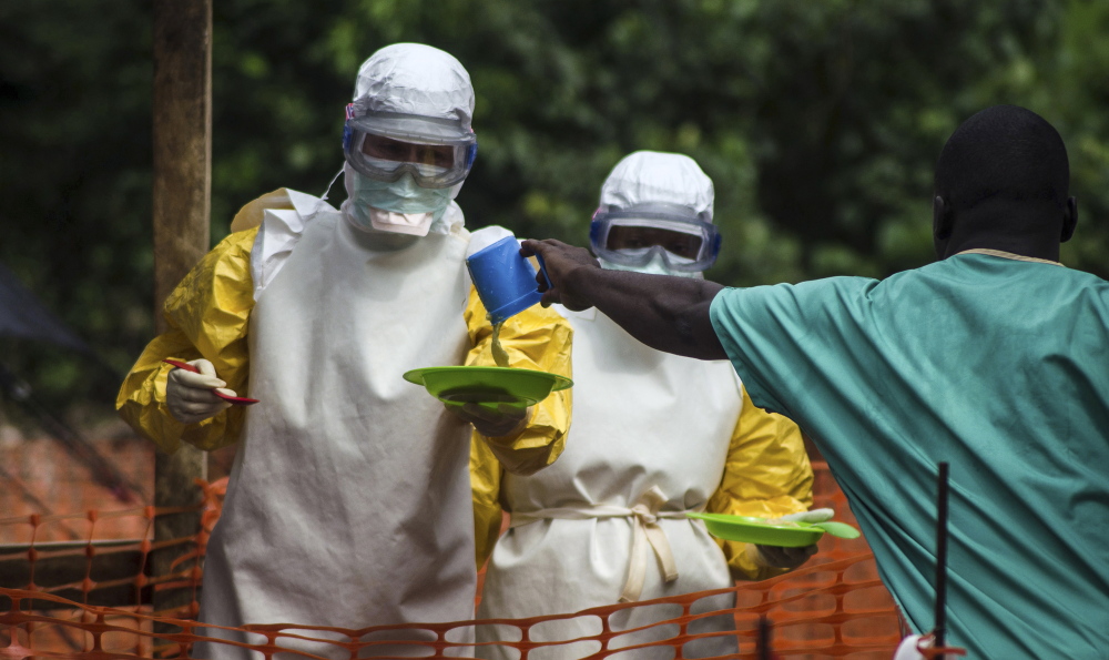 Medical staff working with Medecins sans Frontieres prepare to bring food to patients in a treatment center in Sierra Leone. Martin Meltzer’s worst-case model of the Ebola epidemic galvanized help for victims.
