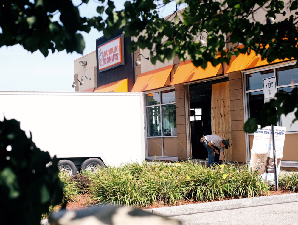 Repairs are made to the Biddeford Dunkin’ Donuts on Spruce Street, after a minivan plowed through the side of the building, causing multiple injuries on Saturday.