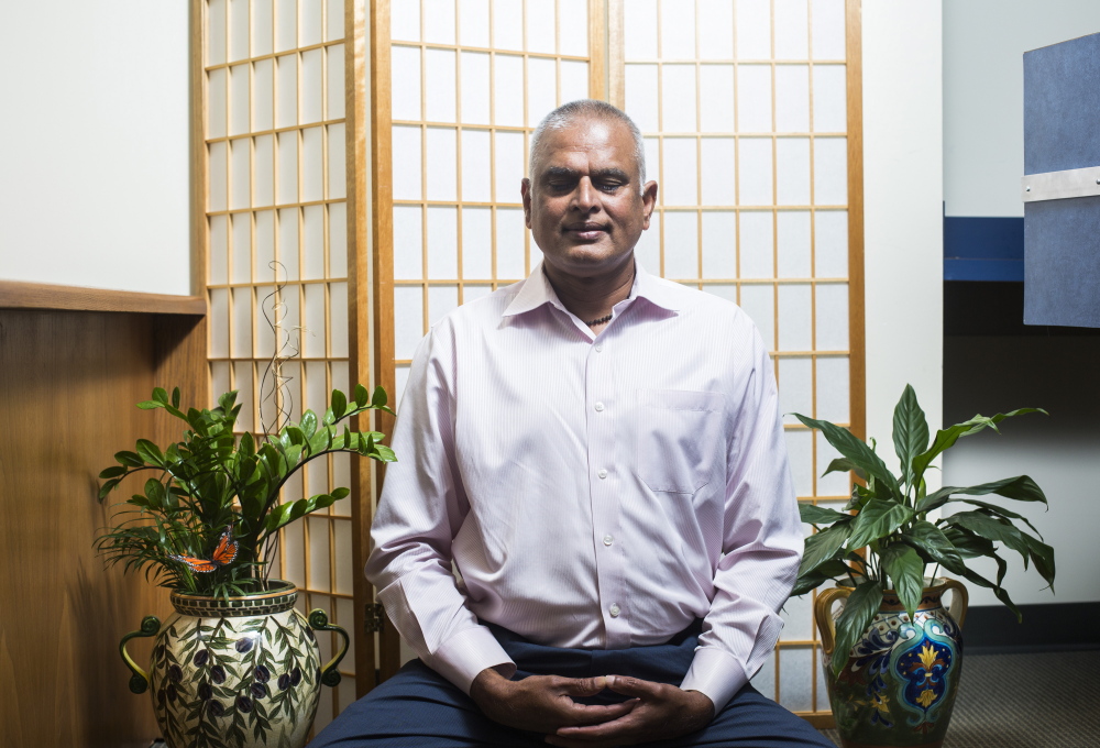 Ashok Nalamalapu of the South Portland IT company iCST says meditating makes meetings “go smoother.”