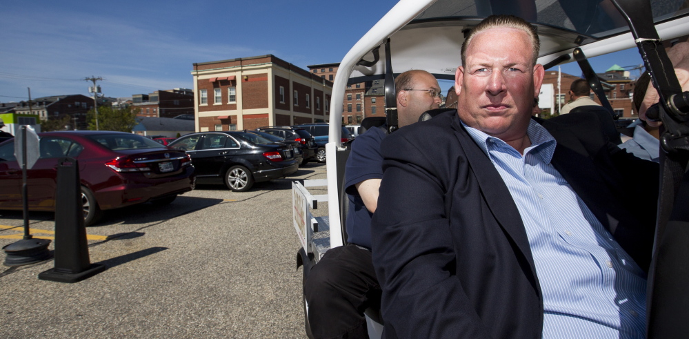 Dan McNutt surveys a parking lot on Commercial Street owned by his company, Unified Parking Partners. McNutt said Unified’s policies are clear and fair, noting that only 1.6 percent of the nearly 25,000 transactions in July, or about 400, resulted in a vehicle being booted.