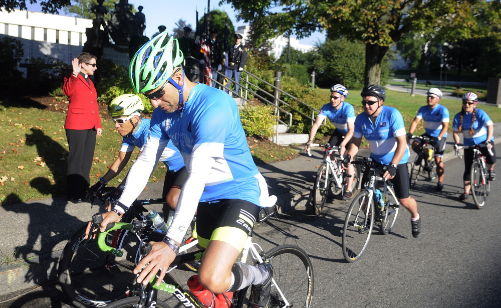 The Rev. Kate Braestrup blesses bicyclists with the New England Chapter of Concerns of Police Survivors as they embark Tuesday morning from Augusta on a three-day, 285-mile ride to support survivors of police officers killed in the line of duty. Breastrup’s first husband, Maine State Trooper Drew Griffith, died on patrol in a car accident in 1996.